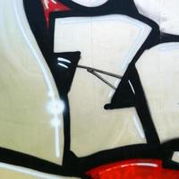 Street art. Abstract background image of a fragment of a colored graffiti painting in chrome and red tones photo