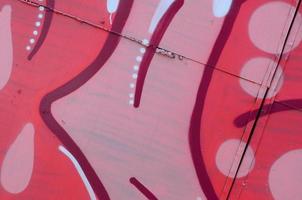 Street art. Abstract background image of a fragment of a colored graffiti painting in red tones photo