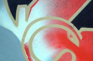 Street art. Abstract background image of a fragment of a colored graffiti painting in red tones photo