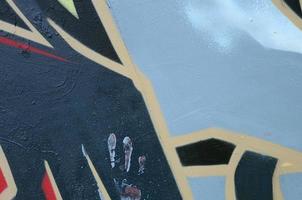 Street art. Abstract background image of a fragment of a colored graffiti painting in dark grey and red tones photo