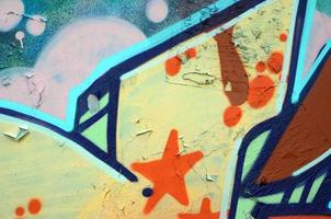 Street art. Abstract background image of a fragment of a colored graffiti painting in beige and orange tones photo