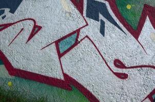 Street art. Abstract background image of a fragment of a colored graffiti painting in chrome and red tones photo