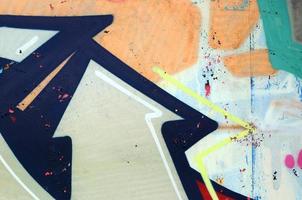 Street art. Abstract background image of a fragment of a colored graffiti painting in white and orange tones photo