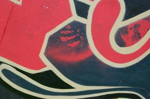 Street art. Abstract background image of a fragment of a colored graffiti painting in red tones photo