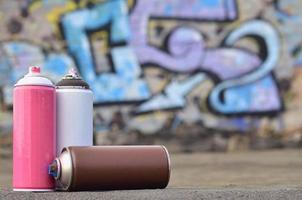 A still-life of several used paint cans of different colors agai photo