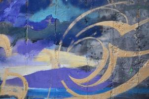 Texture of a fragment of the wall with graffiti painting, which is depicted on it. An image of a piece of graffiti drawing as a photo on street art and graffiti culture topics