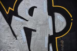 Texture of a fragment of the wall with graffiti painting, which is depicted on it. An image of a piece of graffiti drawing as a photo on street art and graffiti culture topics