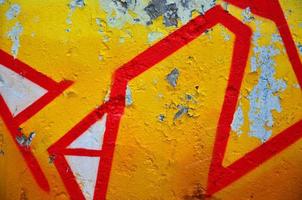 Texture of a fragment of the wall with graffiti painting, which is depicted on it. An image of a piece of graffiti drawing as a photo on street art and graffiti culture topics