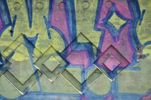 Texture of a fragment of the wall with graffiti painting, which is depicted on it. An image of a piece of graffiti drawing as a photo on street art and graffiti culture topics