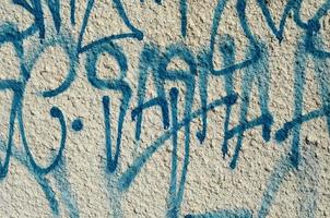 Concrete weathered worn wall damaged paint. Grungy Concrete Surface with graffiti colors and outlines. Street art background texture. Close up painted wall of the city photo