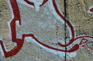 Texture of a fragment of the wall with graffiti painting, which is depicted on it. An image of a piece of graffiti drawing as a photo on street art and graffiti culture topics