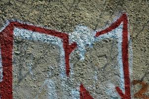 Texture of a fragment of the wall with graffiti painting, which is depicted on it. An image of a piece of graffiti drawing as a photo on street art and graffiti culture topics