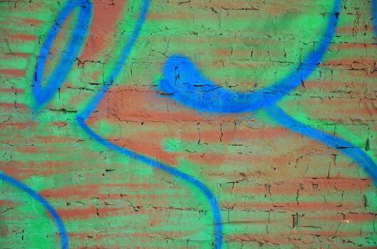 Texture of a fragment of the wall with graffiti painting, which is depicted on it. An image of a piece of graffiti drawing as a photo on street art and graffiti culture topics