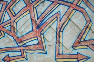 Texture of a fragment of the wall with graffiti painting, which is depicted on it. An image of a piece of graffiti drawing as a photo on street art and graffiti culture topics