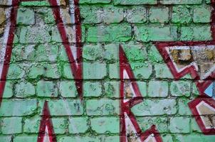 Detailed image of very old and aged color graffiti drawing on the wall. Background grunge street art picture photo