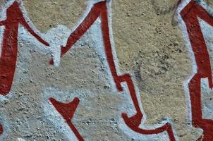 Texture of a fragment of the wall with graffiti painting, which is depicted on it. An image of a piece of graffiti drawing as a photo on street art and graffiti culture topics