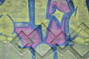 Texture of a fragment of the wall with graffiti painting, which is depicted on it. An image of a piece of graffiti drawing as a photo on street art and graffiti culture topics