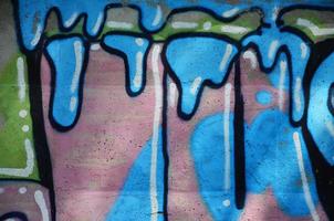 Texture of a fragment of the wall with graffiti painting, which is depicted on it. An image of a piece of graffiti drawing as a photo on street art and graffiti culture topics