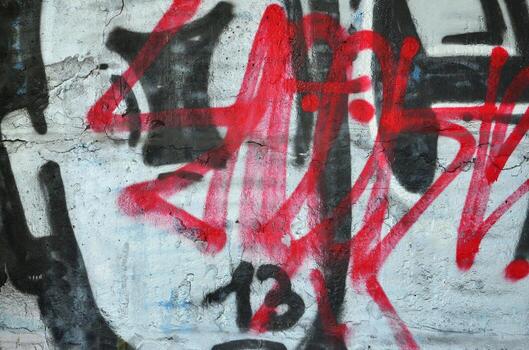 Texture of a fragment of the wall with graffiti painting, which is depicted on it. An image of a piece of graffiti drawing as a photo on street art and graffiti culture topics