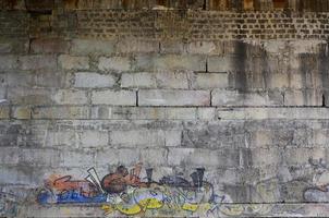 Detailed image of very old and aged color graffiti drawing on the wall. Background grunge street art picture photo