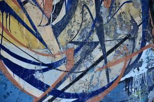 Detailed image of very old and aged color graffiti drawing on the wall. Background grunge street art picture photo