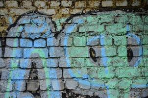 Detailed image of very old and aged color graffiti drawing on the wall. Background grunge street art picture photo