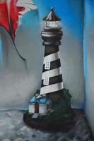 Detailed image of color graffiti drawing. Background Street art background with a painted sea lighthouse photo