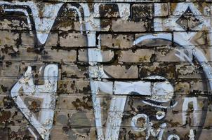 Detailed image of very old and aged color graffiti drawing on the wall. Background grunge street art picture photo