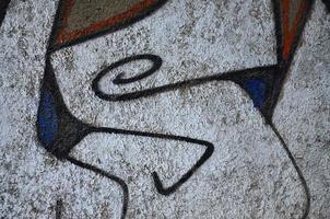 Detailed image of very old and aged color graffiti drawing on the wall. Background grunge street art picture photo