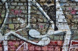 Detailed image of very old and aged color graffiti drawing on the wall. Background grunge street art picture photo