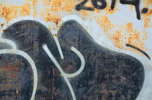 Detailed image of very old and aged color graffiti drawing on the wall. Background grunge street art picture photo