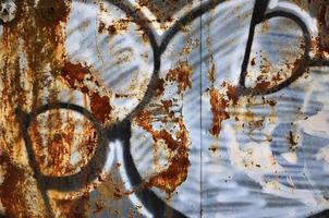 Detailed image of very old and aged color graffiti drawing on the wall. Background grunge street art picture photo