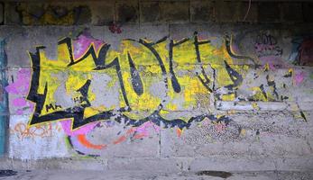 Detailed image of very old and aged color graffiti drawing on the wall. Background grunge street art picture photo