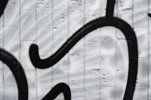 A fragment of a graffiti pattern, applied to a wall of cold tiles, which is covered with a fine condensate. The concept of street art in inappropriate weather photo