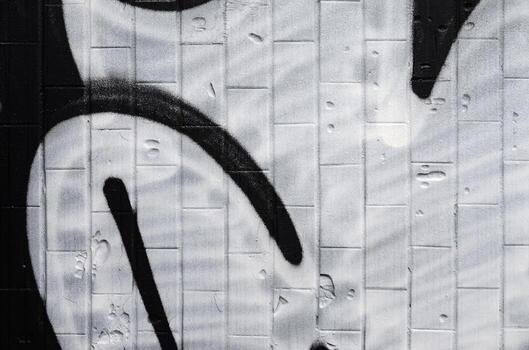 A fragment of a graffiti pattern, applied to a wall of cold tiles, which is covered with a fine condensate. The concept of street art in inappropriate weather photo