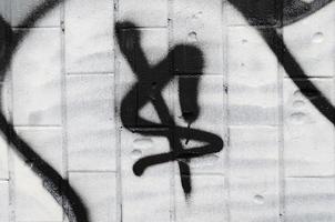 The dollar symbol is painted in graffiti style, applied to the wall from the old tile under the influence of condensate. The concept of street art and vandalism photo