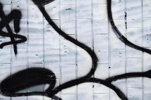 A fragment of a graffiti pattern, applied to a wall of cold tiles, which is covered with a fine condensate. The concept of street art in inappropriate weather photo