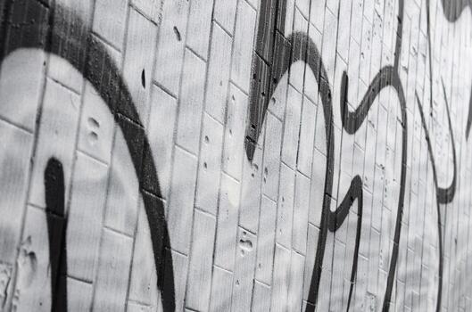 A fragment of a graffiti pattern, applied to a wall of cold tiles, which is covered with a fine condensate. The concept of street art in inappropriate weather photo