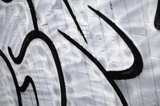 A fragment of a graffiti pattern, applied to a wall of cold tiles, which is covered with a fine condensate. The concept of street art in inappropriate weather photo