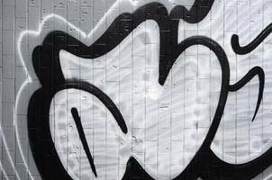 A fragment of a graffiti pattern, applied to a wall of cold tiles, which is covered with a fine condensate. The concept of street art in inappropriate weather photo