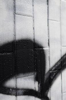 A fragment of a graffiti pattern, applied to a wall of cold tiles, which is covered with a fine condensate. The concept of street art in inappropriate weather photo
