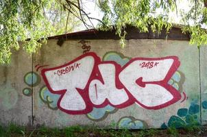 Street art. Abstract background image of a full completed graffiti painting in chrome fill, green background and red outlines photo