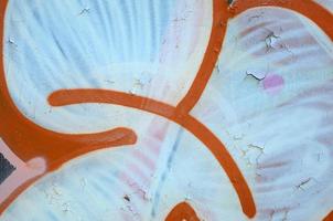 Street art. Abstract background image of a fragment of a colored graffiti painting in white and orange tones photo