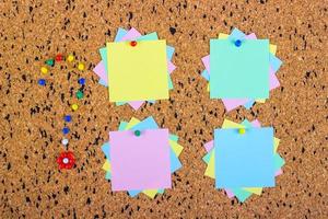 colorful sticky notes on cork bulletin board. Question mark made of pushpins photo
