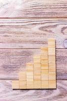 A wooden blocks cube over black wooden textured background with copy space for add word text title. Concept or conceptual Wood block stair or six steps. Cubic photo