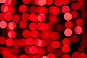 Unfocused abstract red bokeh on black background. defocused and blurred many round light photo