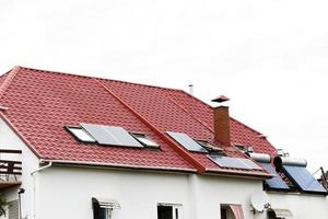 a roof with solar panels or a photovoltaic plant on the sky background photo