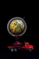 Red toy truck carrying a globe photo