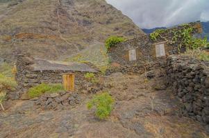 Beautiful rural view with abandoned stone house photo