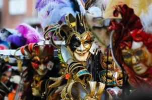 Unidentified people wearing carnival masks at the Venice Carnival in Venice, Italy, circa February 2022 photo